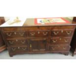 A George III stained oak dresser base with three frieze drawers, over a panelled door,