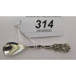 A silver caviar spoon with a floral cast stem 11