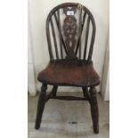 A child's late 18thC elm and ash chair with a Windsor design wheel carved back and seat,