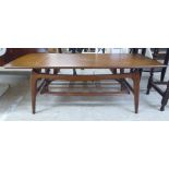 A late 1960s teak coffee table, the top raised on tapered legs,