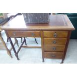 An early 20thC mahogany single pedestal five drawer desk, raised on tapered,