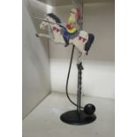 A painted iron novelty mobile toy, fashioned as medieval mounted knight in armour,
