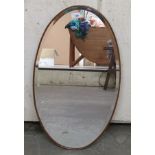 An oval bevelled mirror,