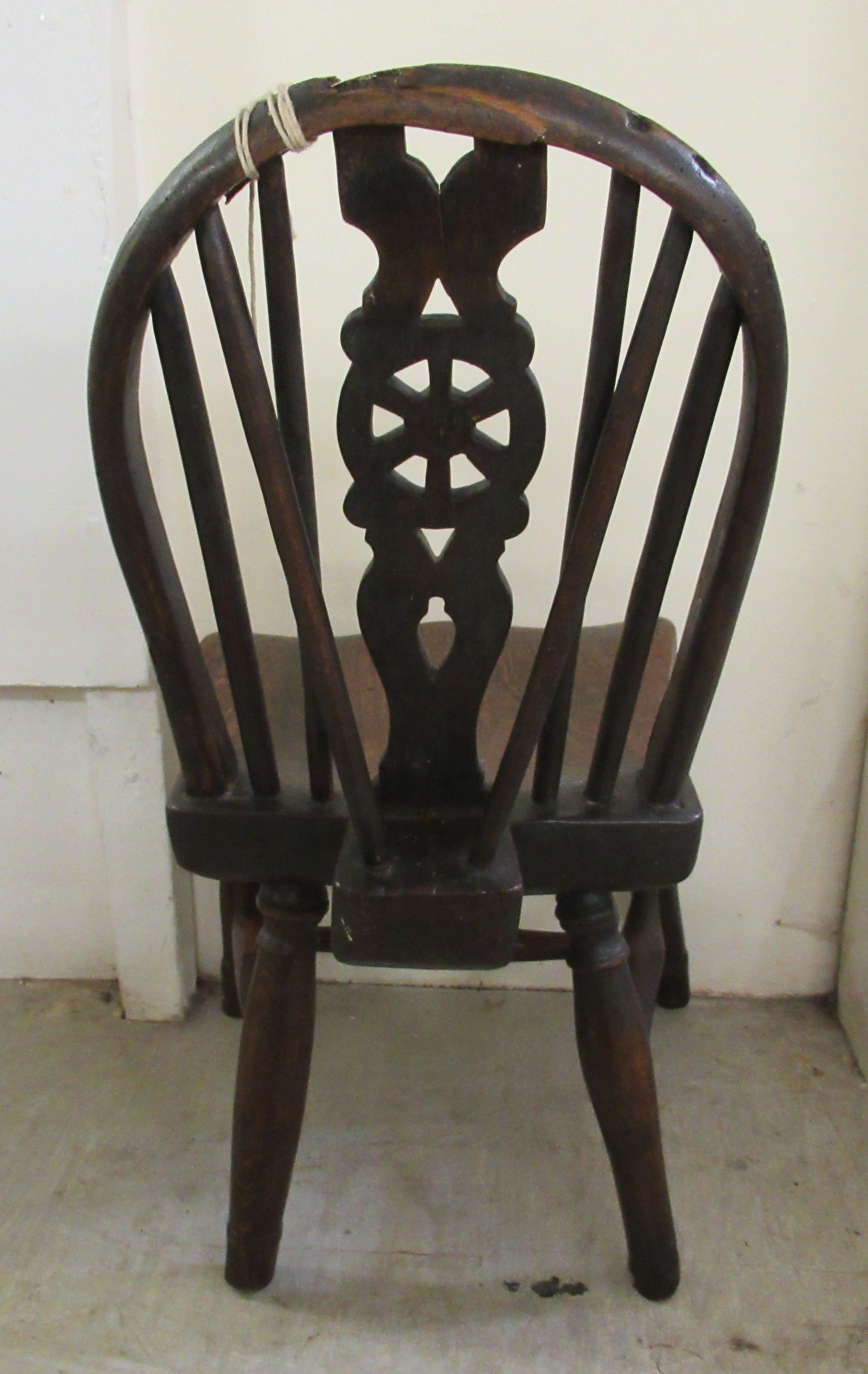 A child's late 18thC elm and ash chair with a Windsor design wheel carved back and seat, - Image 2 of 3