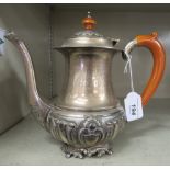 An Asian silver coloured metal coffee pot of bulbous form with a tapered, waisted neck swept spout,