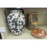 A white marble effect and matt black glazed, twin handled, baluster shaped vase,