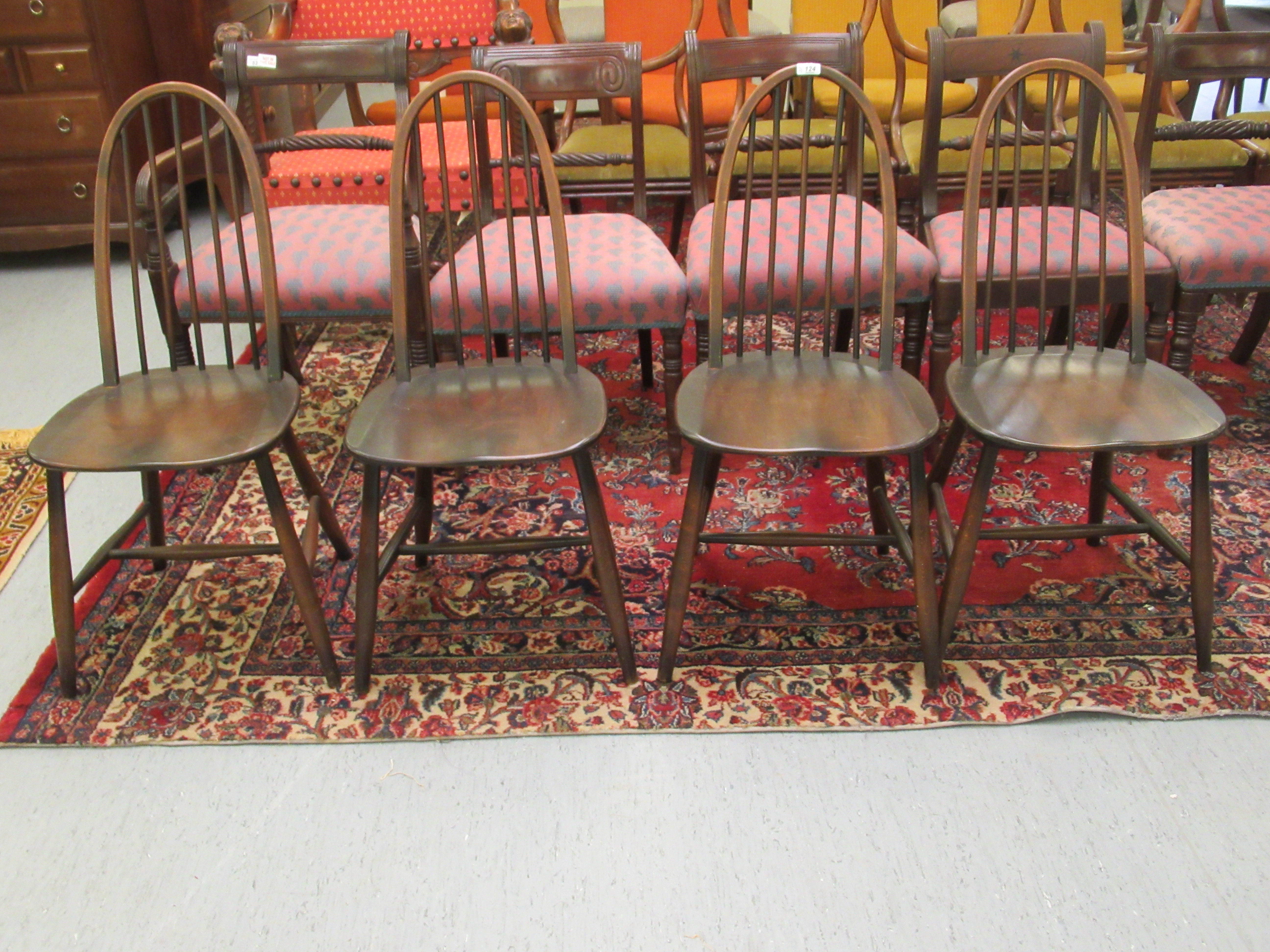 A set of four dark stained Ercol high hoop and spindled back chairs,