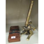 An early 20thC lacquered brass microscope 16''h;