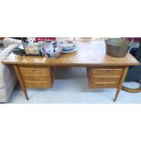 A 1970s teak six drawer twin pedestal desk,