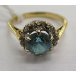An 18ct gold claw set blue topaz and diamond cluster ring 11