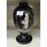 A late Victorian black glass vase,