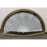 A late 19thC white lace trimmed and sequinned fan with finely pierced sticks 13''h displayed in a