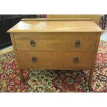 An early 20thC light oak two drawer dressing chest,