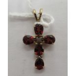 A 9ct gold claw set garnet pendant cross 11