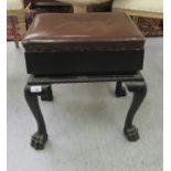 An early 20thC music stool, the cushioned brown hide,