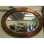 An Arts & Crafts mirror, the bevelled plate set in a nailed copper frame,