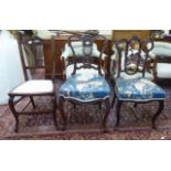 A pair of Edwardian mahogany framed salon chairs with carved splats and overstuffed seats,