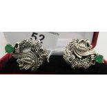 A pair of silver dragon and lion cufflinks,