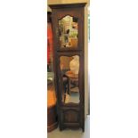 A 1930s tall oak cabinet with two mirrored doors and a panelled door 80''h 18.