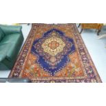 A Persian rug, decorated with a central serpentine outlined medallion,