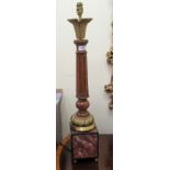 A modern table lamp with a fluted oak column,