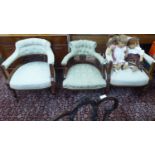 A pair of late Victorian mahogany framed, horseshoe shaped salon chairs with a button upholstered,