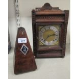 A 1930s oak cased clock, faced by a Roman dial 10''h 8''w; and a later beech cased metronome 8.