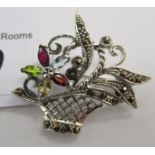 A silver and coloured stone set brooch,