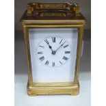 An Edwardian lacquered brass cased carriage timepiece;