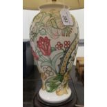 A modern Moorcroft table lamp of tapered, baluster form, decorated in tubeline with flora,