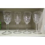 A set of four 20thC stemmed wine glasses etched with game OS4