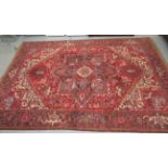 A Karian carpet with floral motifs on a red ground 136'' x 84'' BL