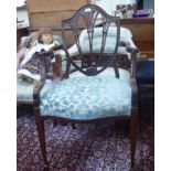 An Edwardian mahogany framed shield back dining chair with swept open arms and an overstuffed,
