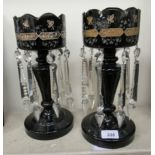 A pair of late Victorian black glass lustre vases,