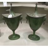 A pair of Regency cast metal green painted urns and covers 14''h OS7