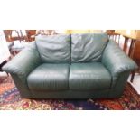 A modern Chesterfield style two person settee, upholstered in soft, bottle green hide,