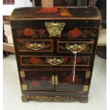 A Chinese red lacquered and overpainted collector's chest with a hinged lid,