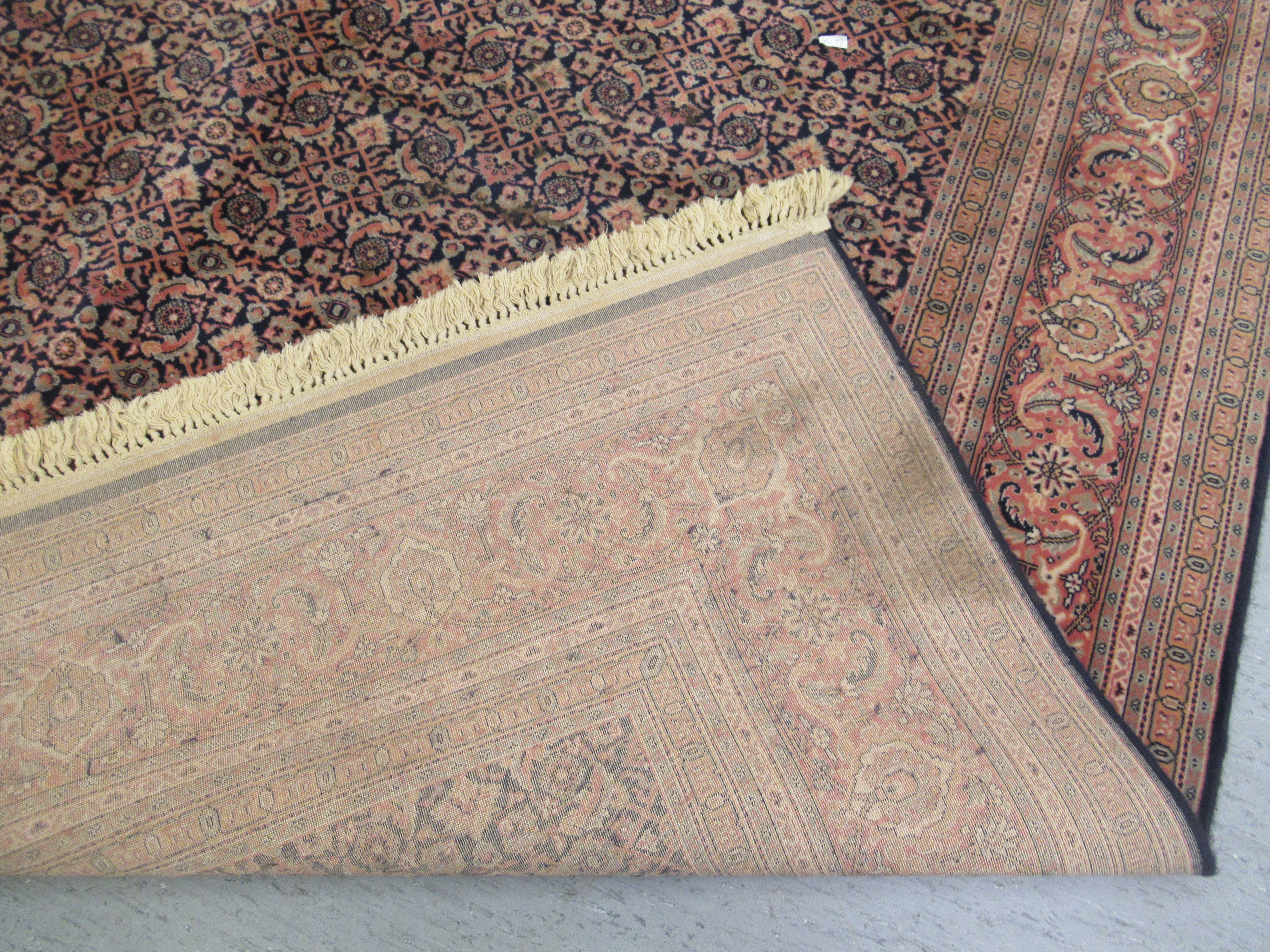 A Persian rug with floral motifs, - Image 4 of 4