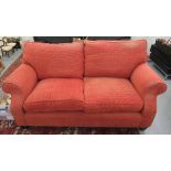 A modern two person settee with a low back and scrolled arms,