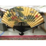 A modern Japanese black lacquered and overpainted gilded fan 42''h 64''w (open) BSR