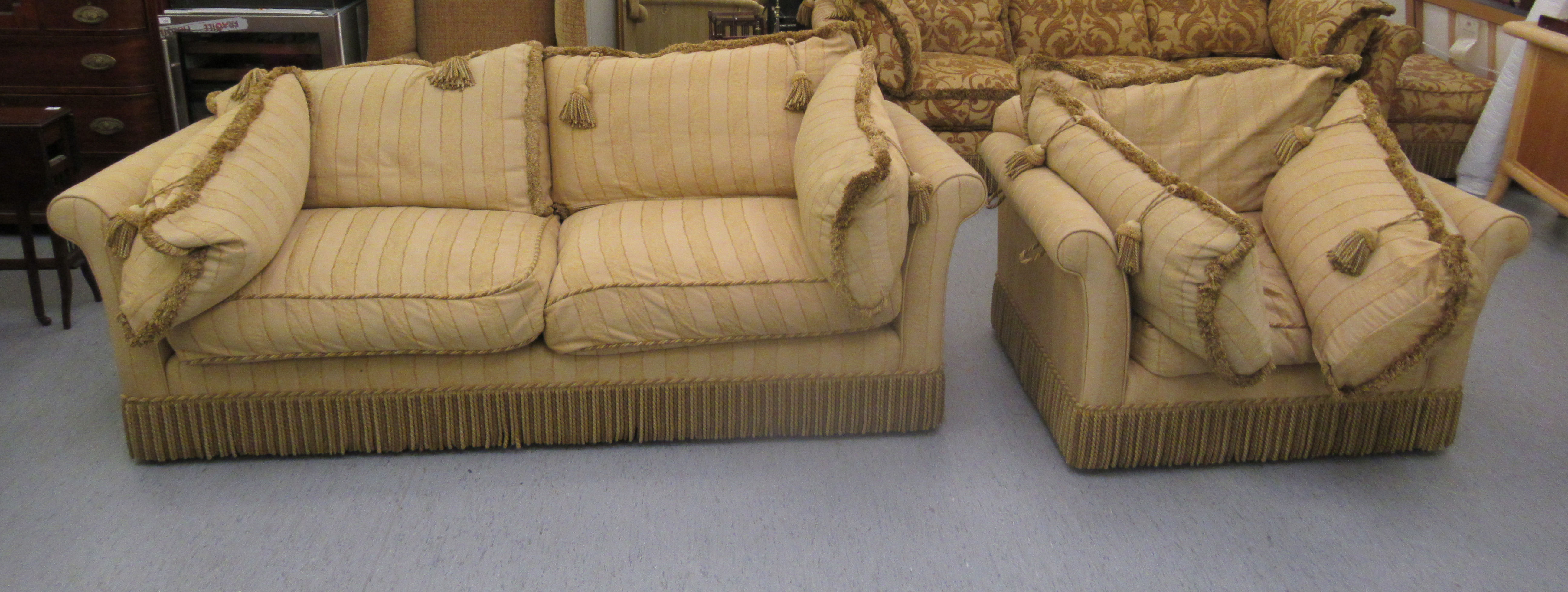 A modern two person settee with a low back and level scrolled arms,