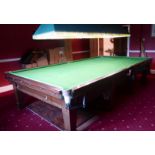 An oak, full size, slate bed, green baize lined snooker table, raised on eight, square,