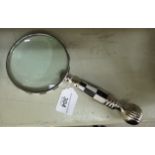 A magnifying glass with a black and white composition handle OS1