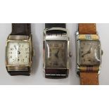 Three similar 1950s rectangular cased stainless steel cased wristwatches, viz.