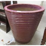 A streaky glazed pottery planter of ribbed,