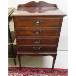 An Edwardian mahogany music cabinet with four fall front drawers, raised on square,