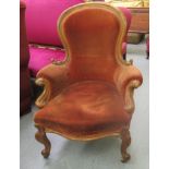 A late Victorian walnut framed spoonback, button upholstered gold coloured fabric salon chair,