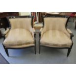 A pair of black lacquered showwood framed salon chairs with level, curved backs and enclosed arms,