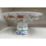 An early 20thC Chinese porcelain altar dish, decorated with flora 3.5''h 6.