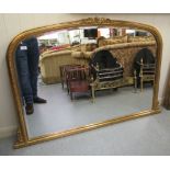 A modern bevelled overmantel mirror, set in a bead bordered,